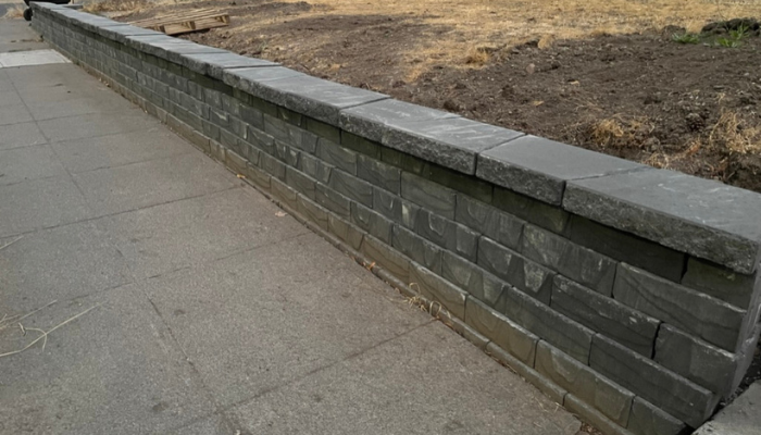 Front yard of house with retaining wall.